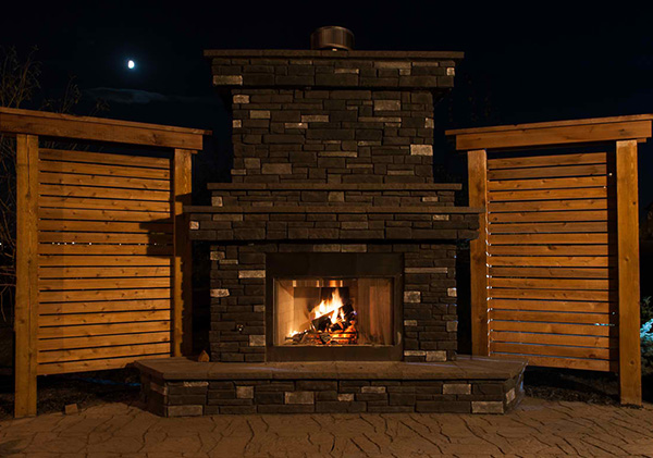 Outdoor fireplace feature in the backyard.