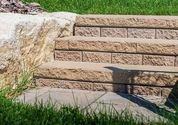 Stone block steps designed into the retaining wall.