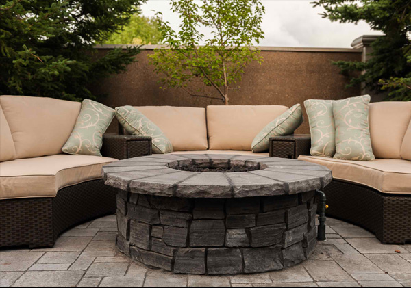 Gas fire pit on back yard patio.