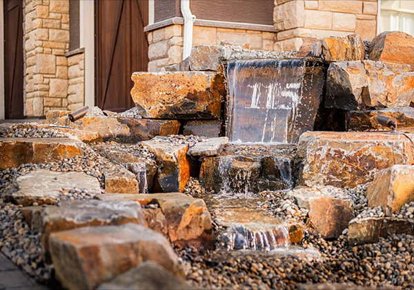 Front yard landscaping with water feature.